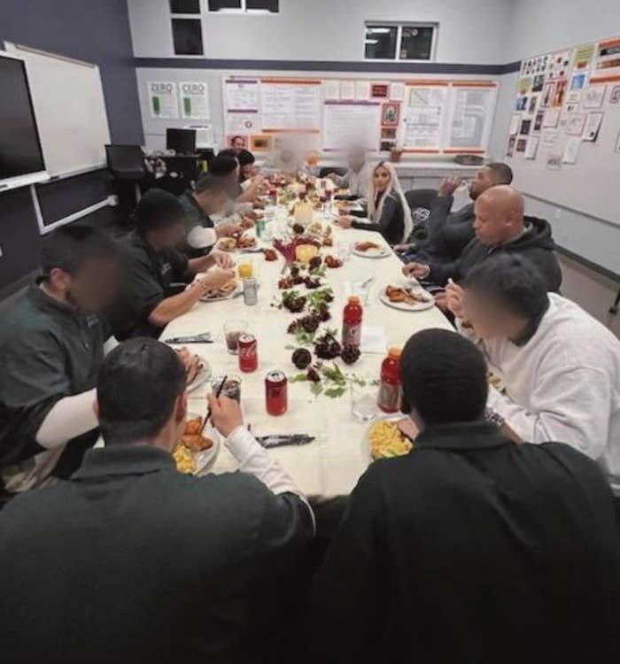 Kim sitting at a dining table with some of the incarcerated men