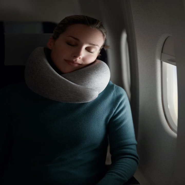 model using grey travel pillow