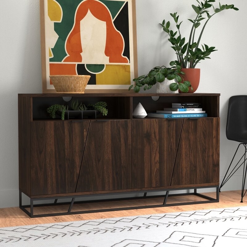 the dark wood sideboard with four cabinets and two open shelves