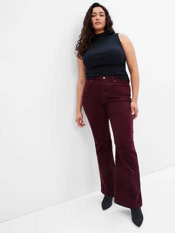 model wearing the plum colored pants with a black tank and boots