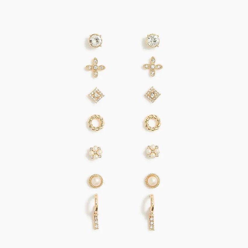 seven varied pairs of small gold earrings with crystal and pearl accents