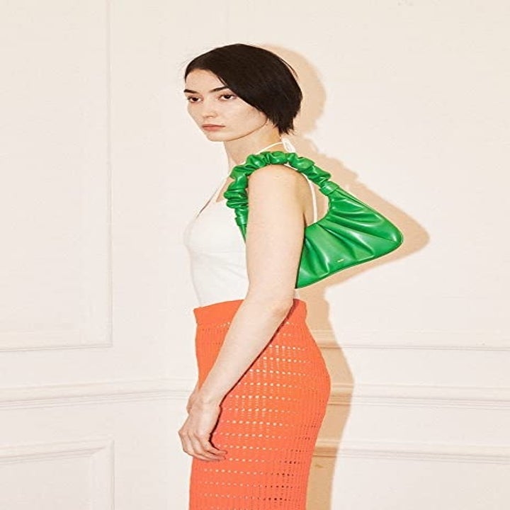 model with green shoulder bag