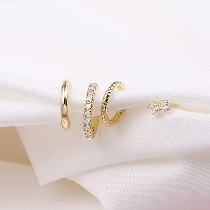 the set of cuffs/earrings on a white cloth