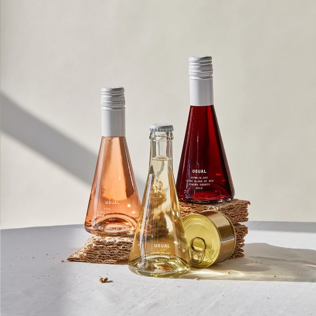 bottles of the wine in rose, red, and white
