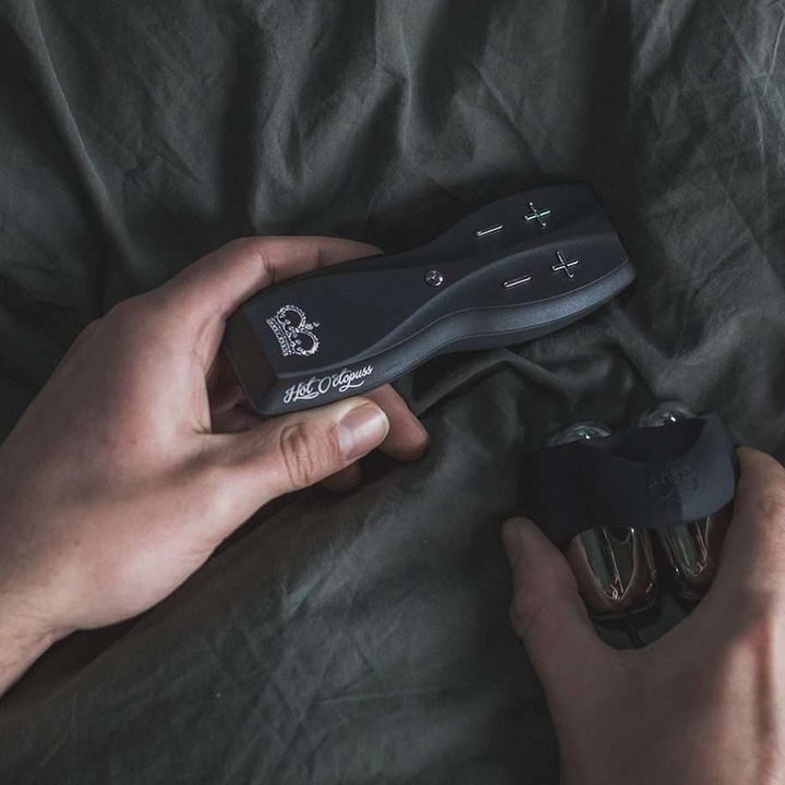 Model holding remote control and penis vibrator