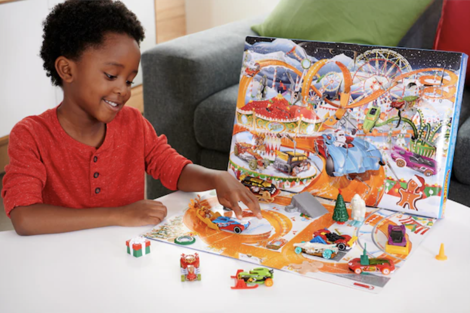 A kid playing with the Hot Wheels calendar