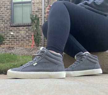 BuzzFeed writer wearing the high tops in grey suede