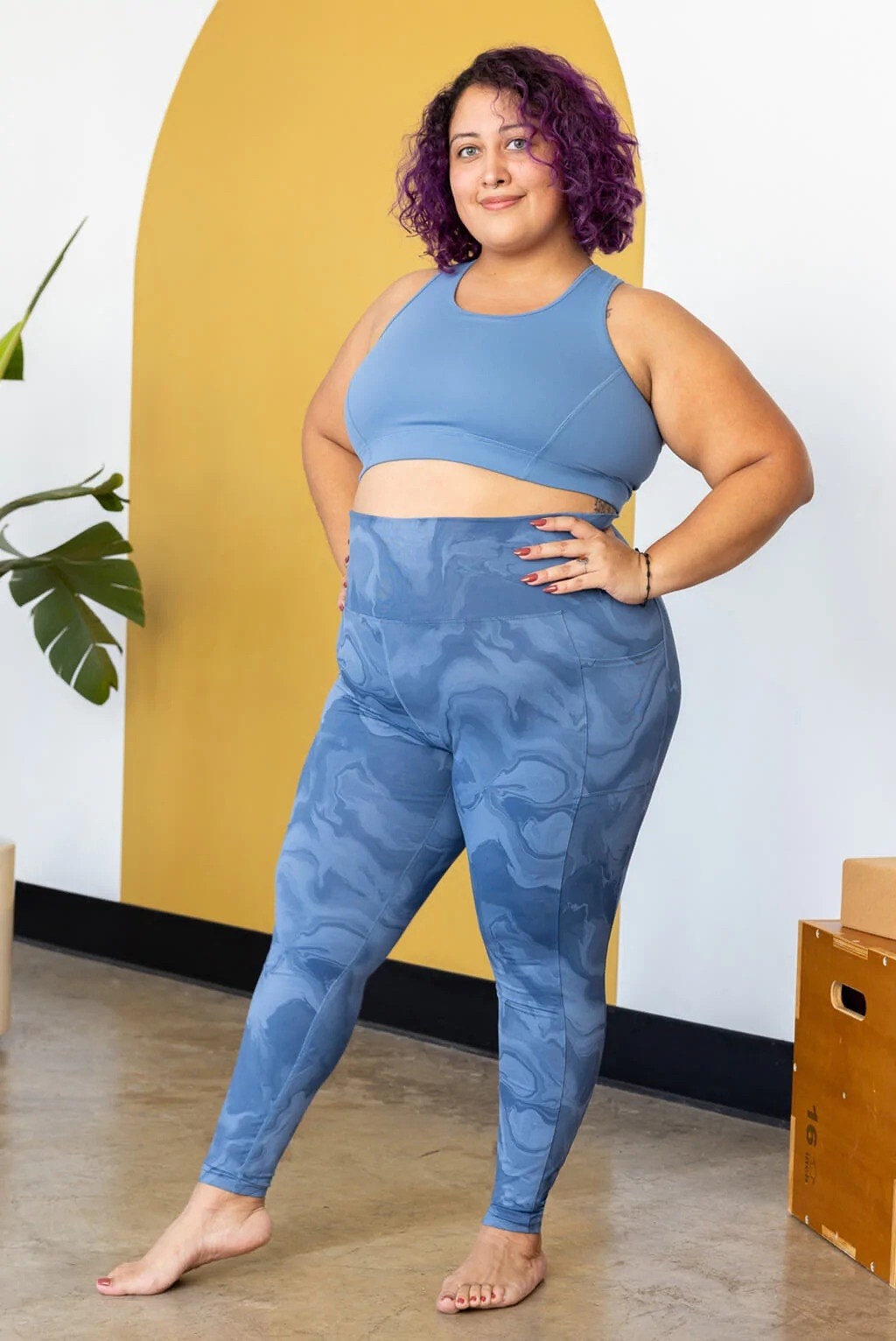 model wearing blue marble-printed high-rise workout leggings