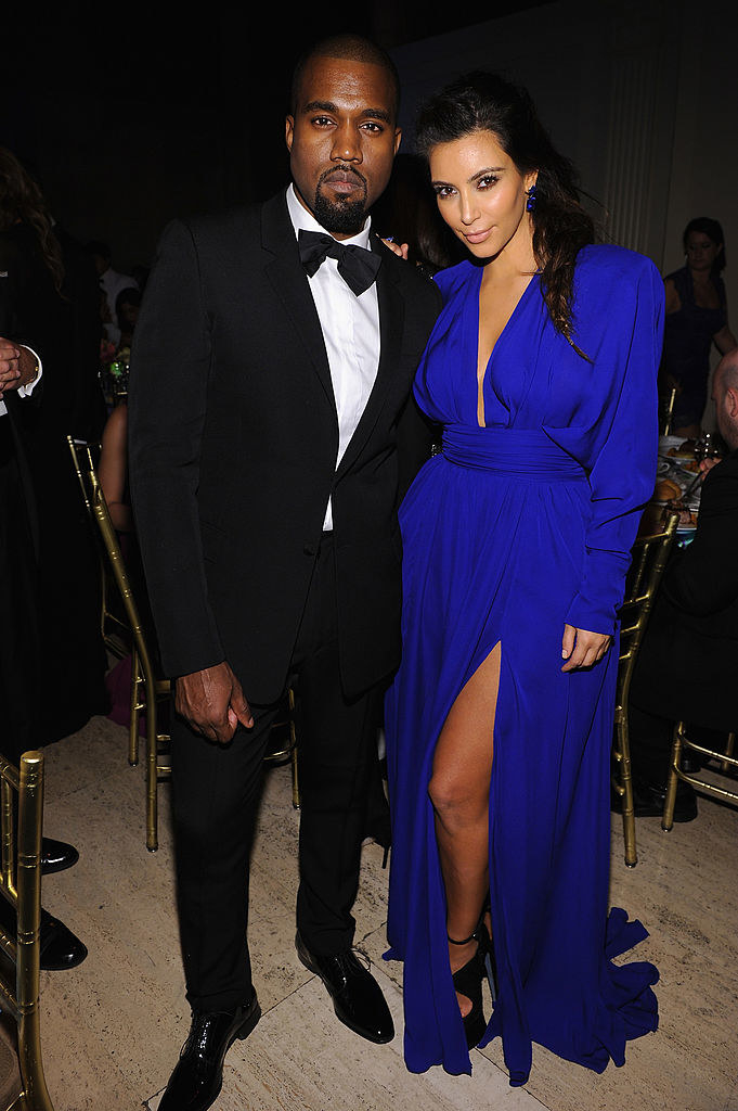 kim wearing the blue dress standing outside with kanye