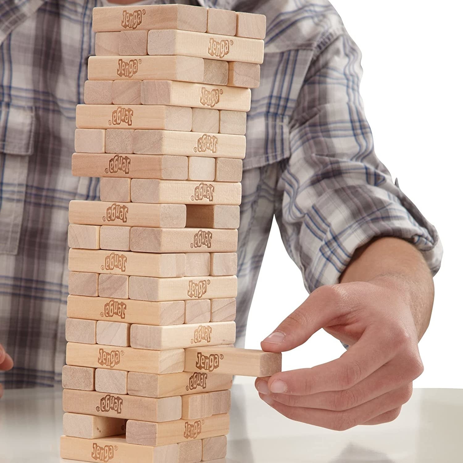 A person taking a tile out of Jenga tower