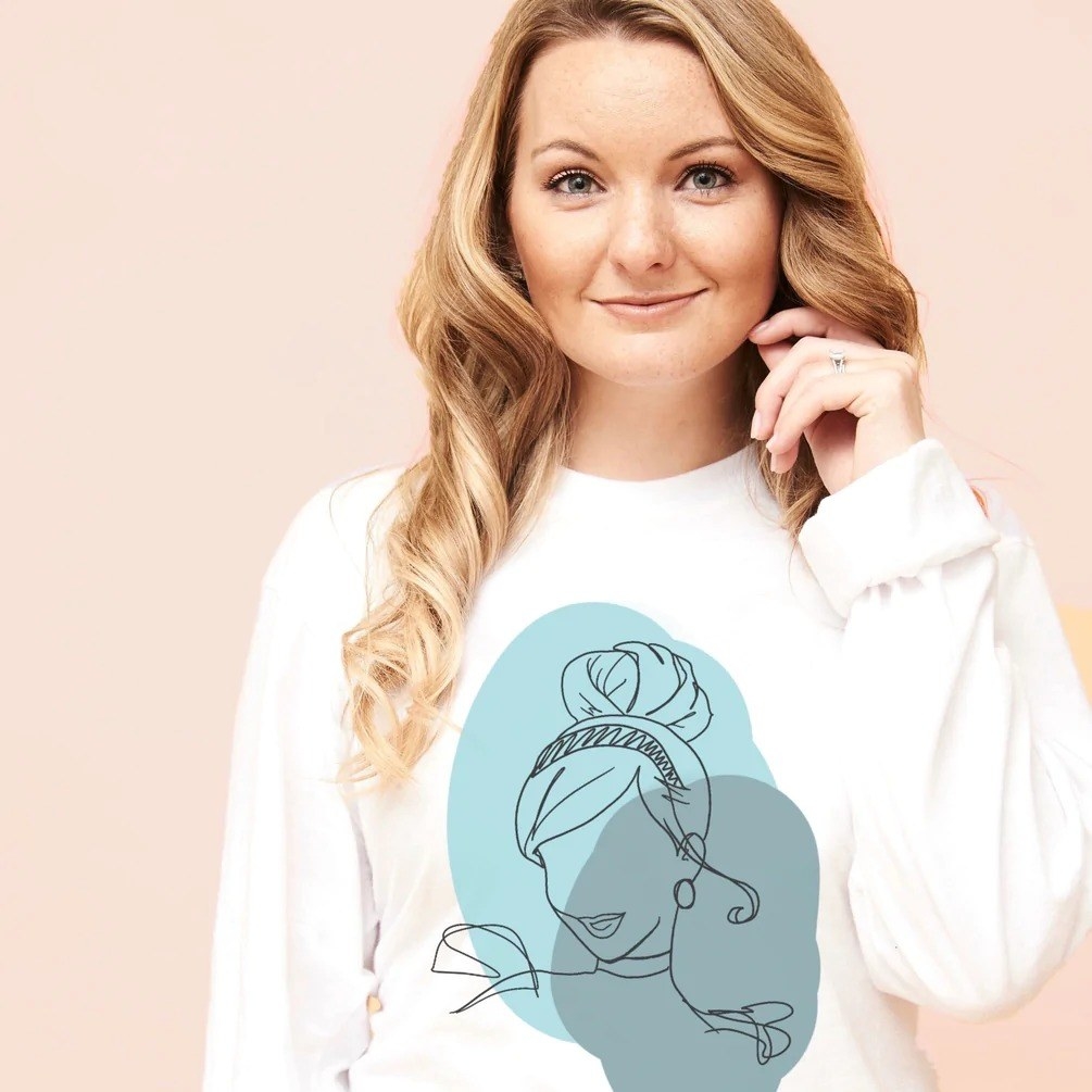 The white sweatshirt with Cinderella&#x27;s head illustration and a blue circle