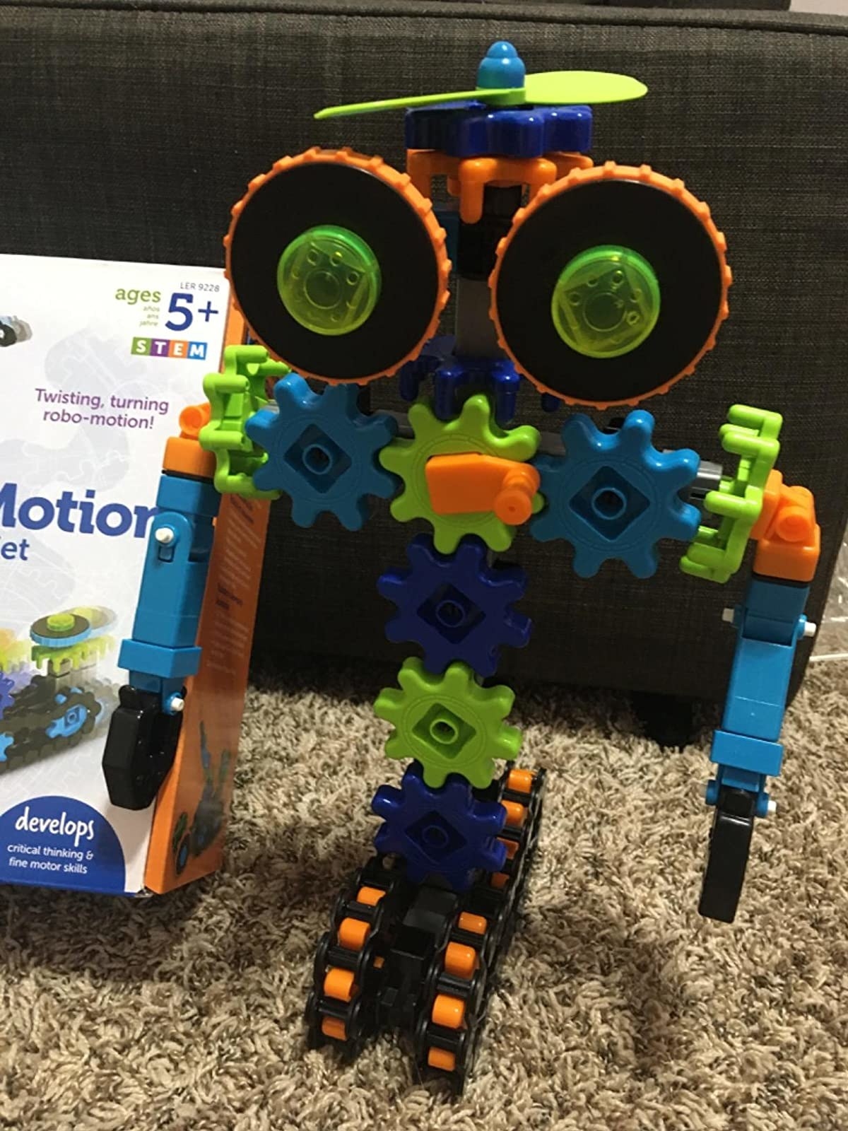 Reviewer&#x27;s image of colorful plastic robot toy and packaging