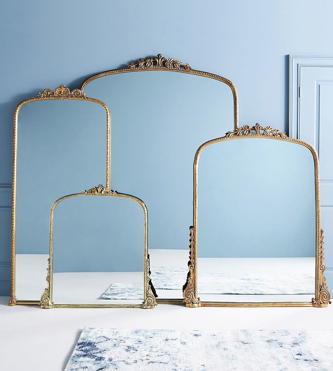 gold framed mirror with square bottom and round ornate tops