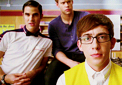 The boys in glee club looking concerned