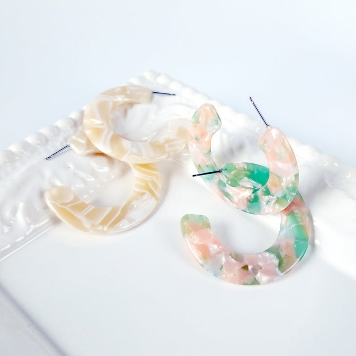 cream and white tortoiseshell earrings, and pink and mint green ones