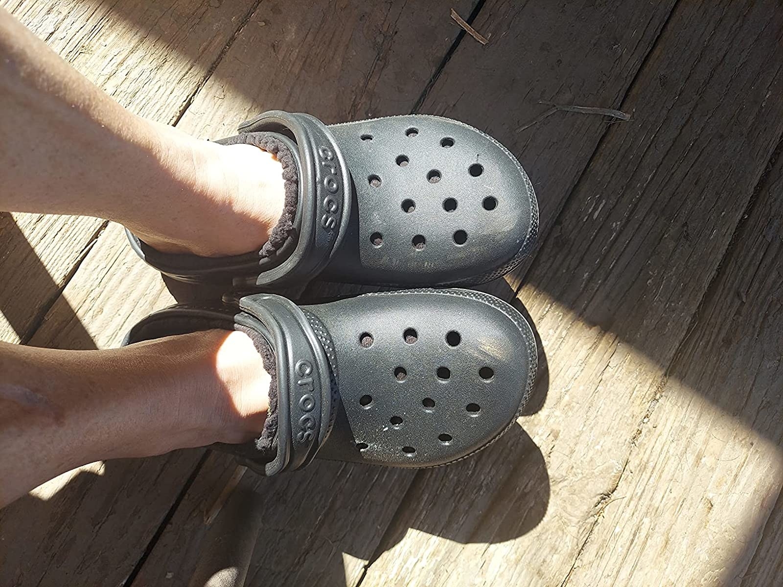 reviewer wearing the black crocs