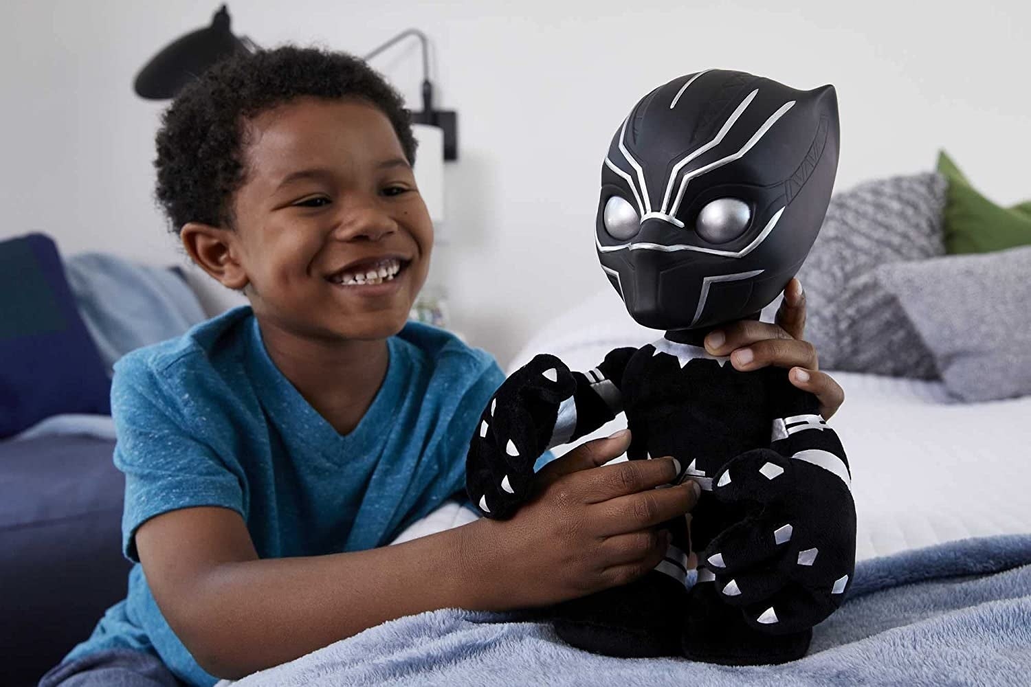 a child playing with the black panther plush