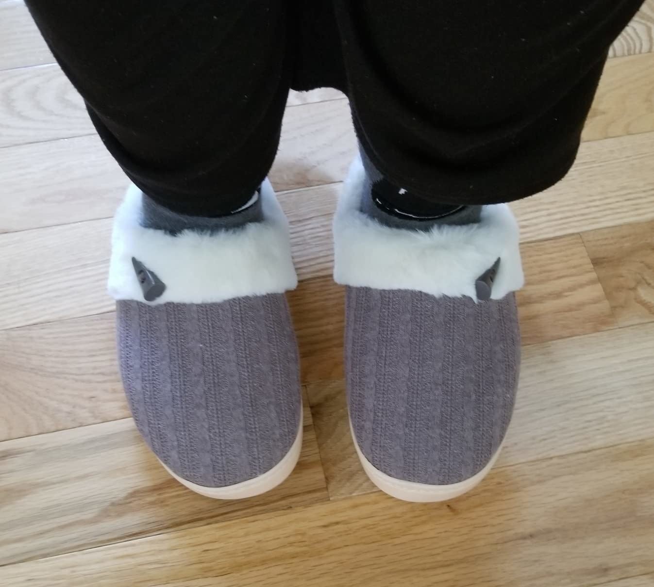 Reviewer wearing the grey slippers