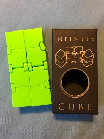 the cube laid flat next to the box