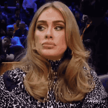 Meme of Adele sitting at the basketball game in the stands and looking around