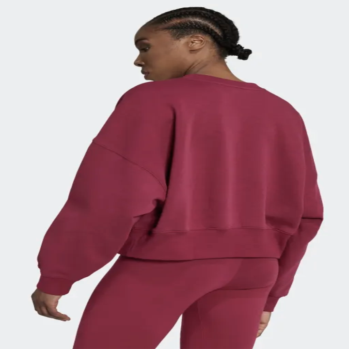 A person showing off the back of the sweatshirt