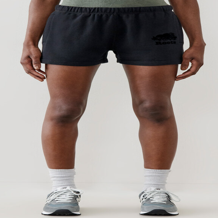 A person wearing shorts, crew socks, and sneakers