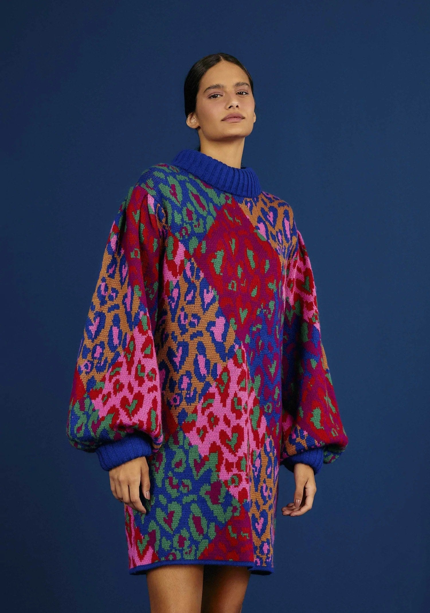 a model wearing a colorful leopard-print sweater dress