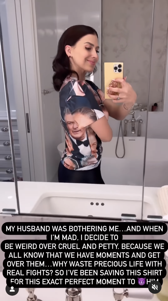 Hilaria taking a selfie while wearing the shirt with Alec&#x27;s face all over it with a caption saying she decided to be &quot;weird over cruel and petty&quot;