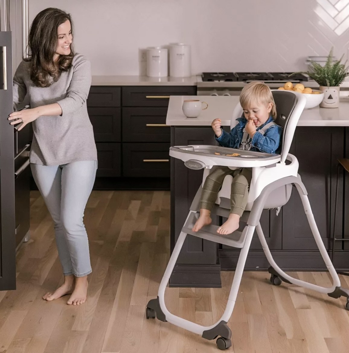 a model next to a baby in the high chair