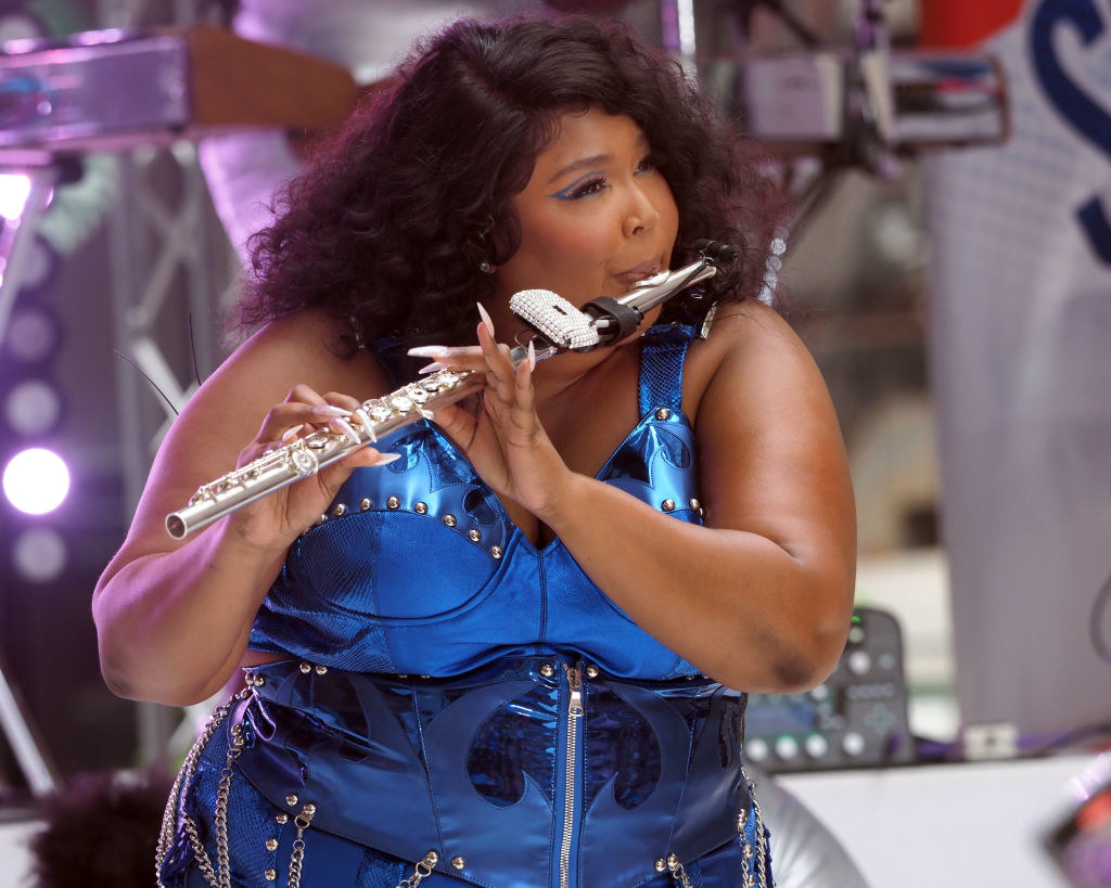 Lizzo playing the flute