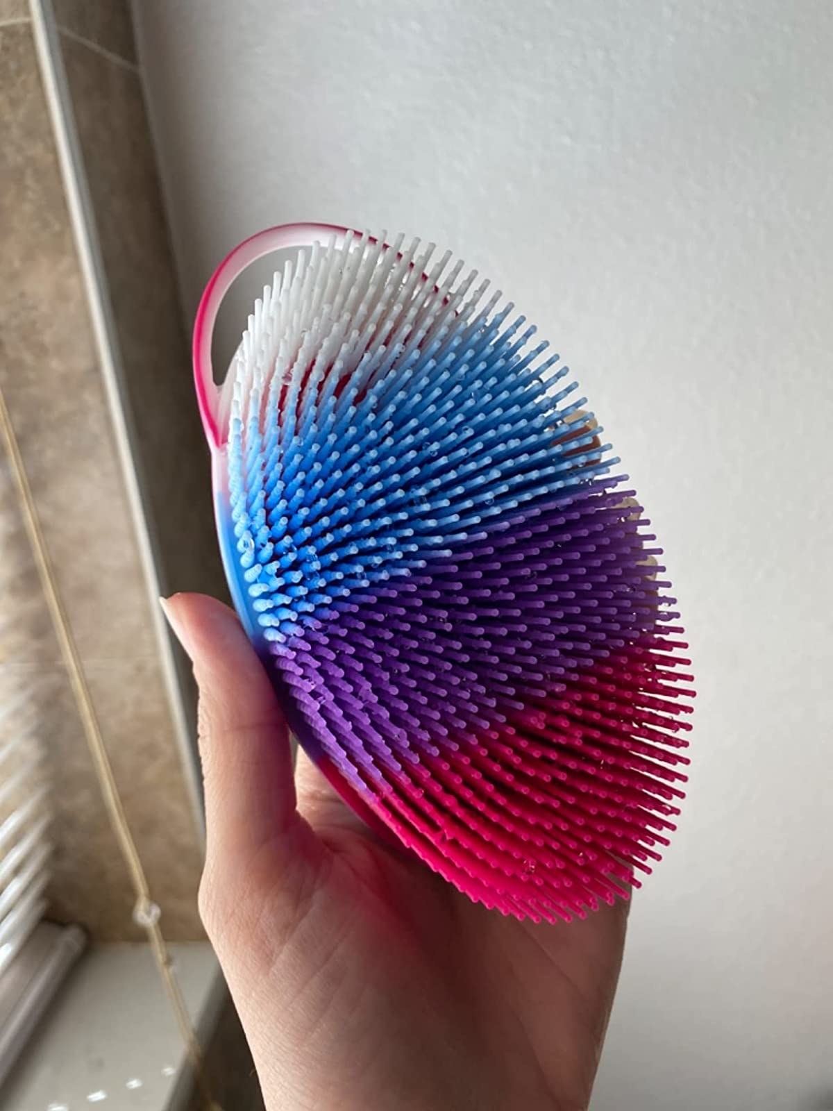 Reviewer holding body scrubber