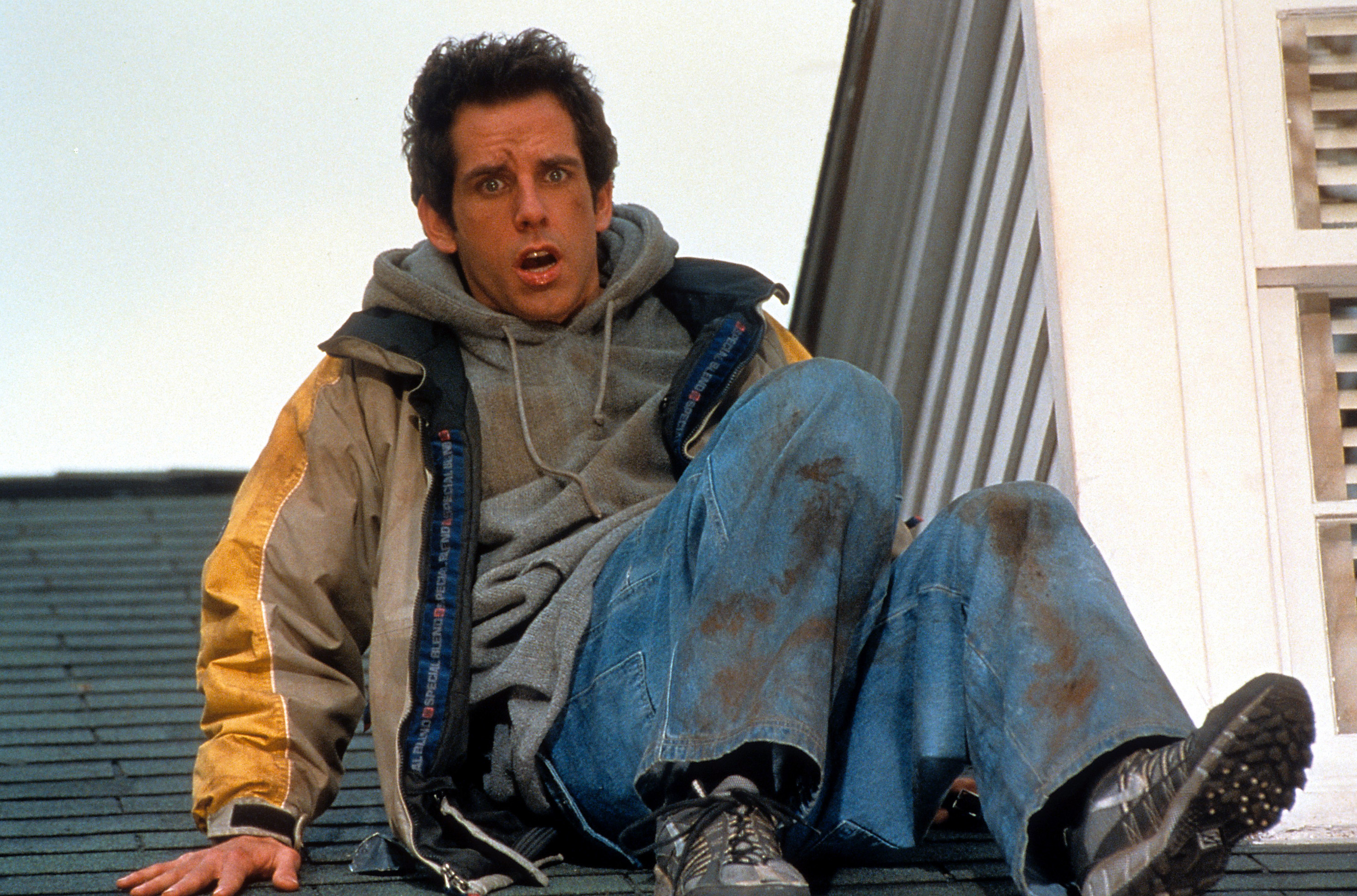 A dirtied Ben Stiller sitting on top of roof in a scene from the film &#x27;Meet The Parents&#x27;, 2000