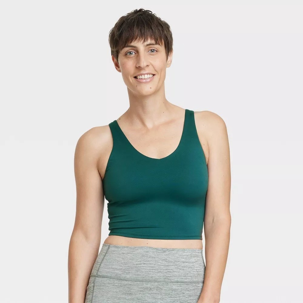 a model wearing the top in forest green