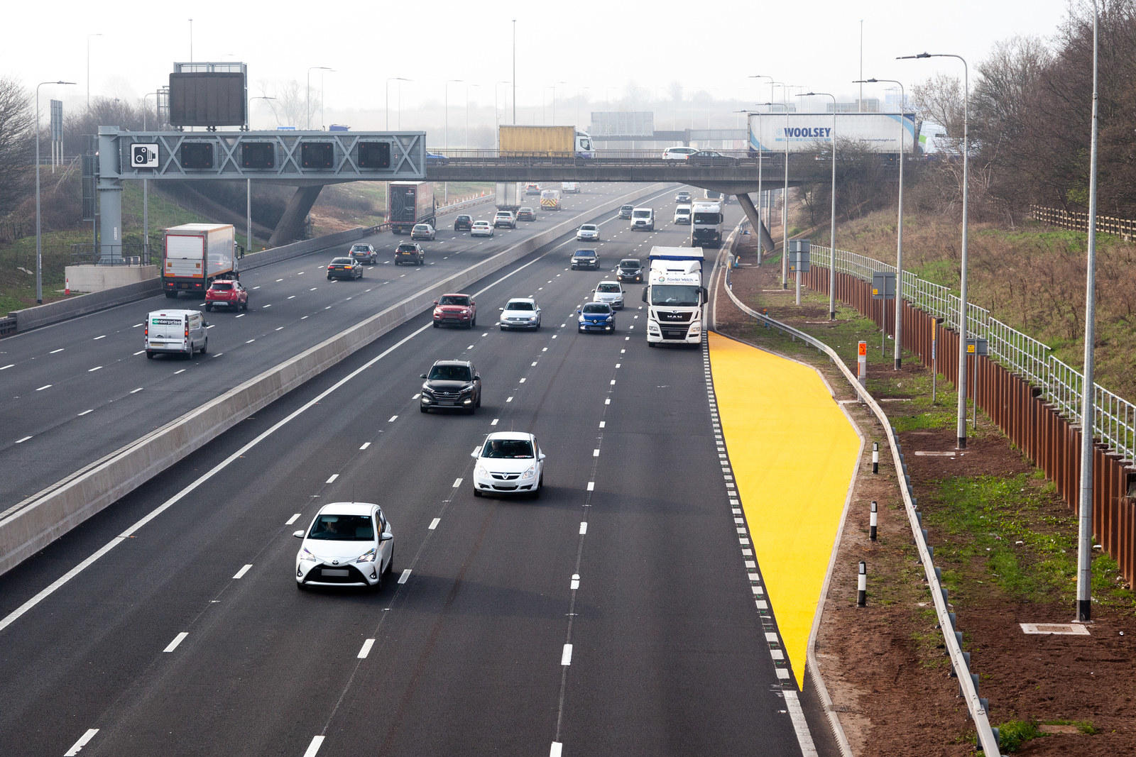 Vehicles driving on a smart motorway with an orange emergency zone