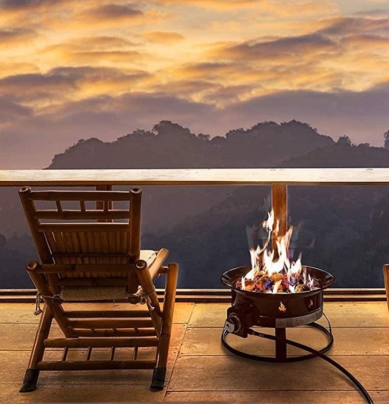 the fire bowl beside a chair on a deck