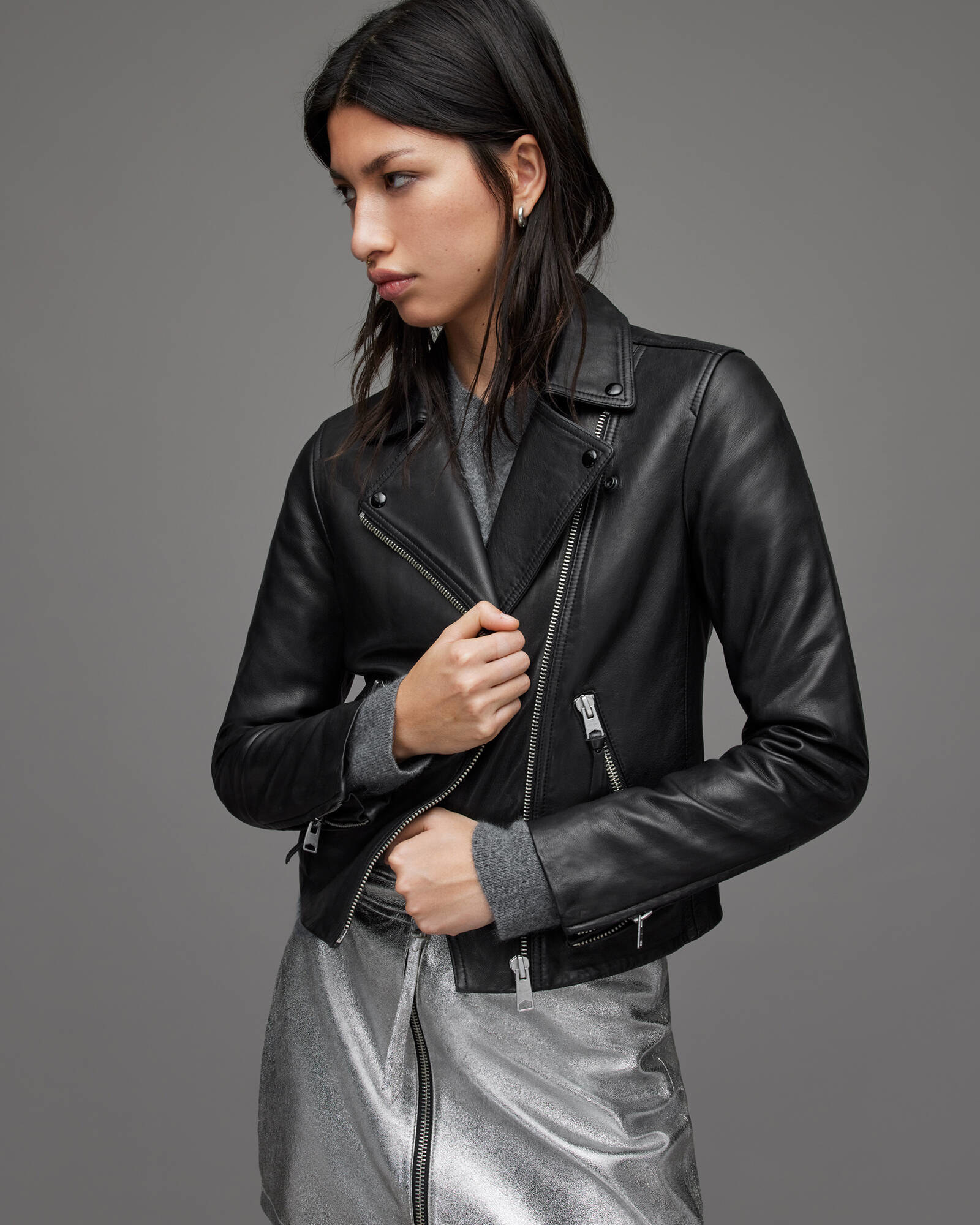 model in black leather jacket with silver hardware