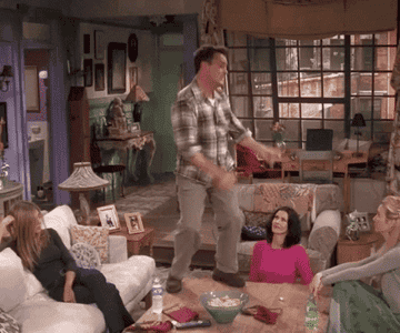 a gif of chandler bing dancing on a table