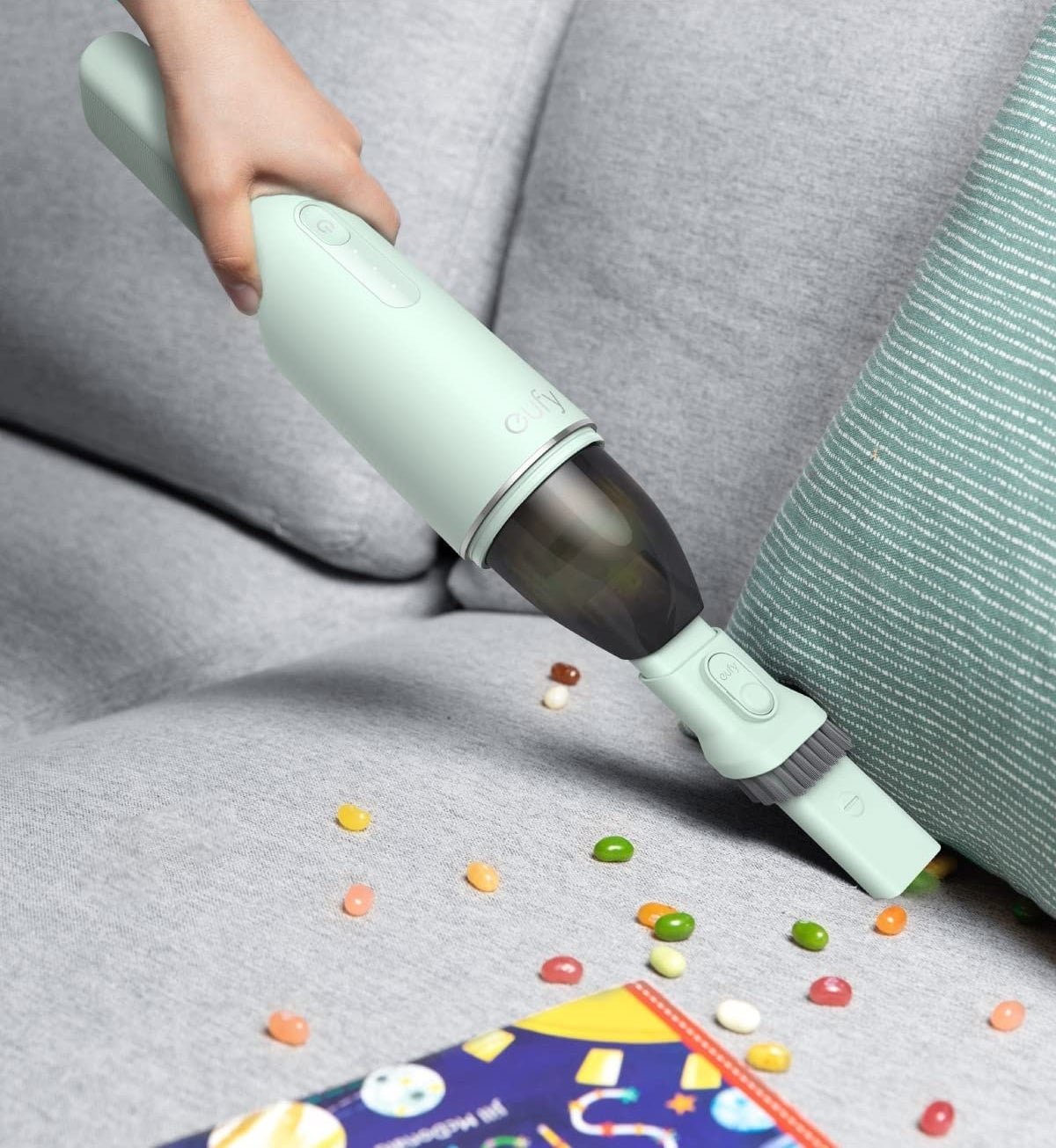 a person using the vacuum to clean up spilled candy
