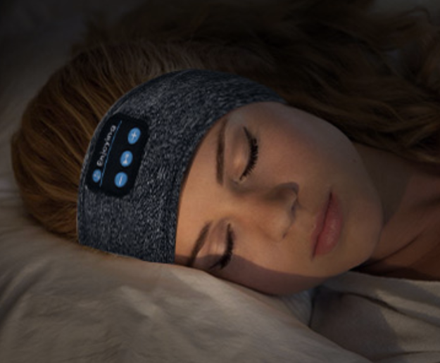 A model sleeping with the headphone band around her ears