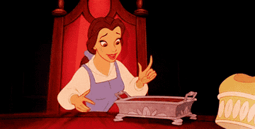 a gif of belle from beauty and the beast tasting desserts