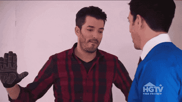 a gif of the property brothers doing a fist bump handshake