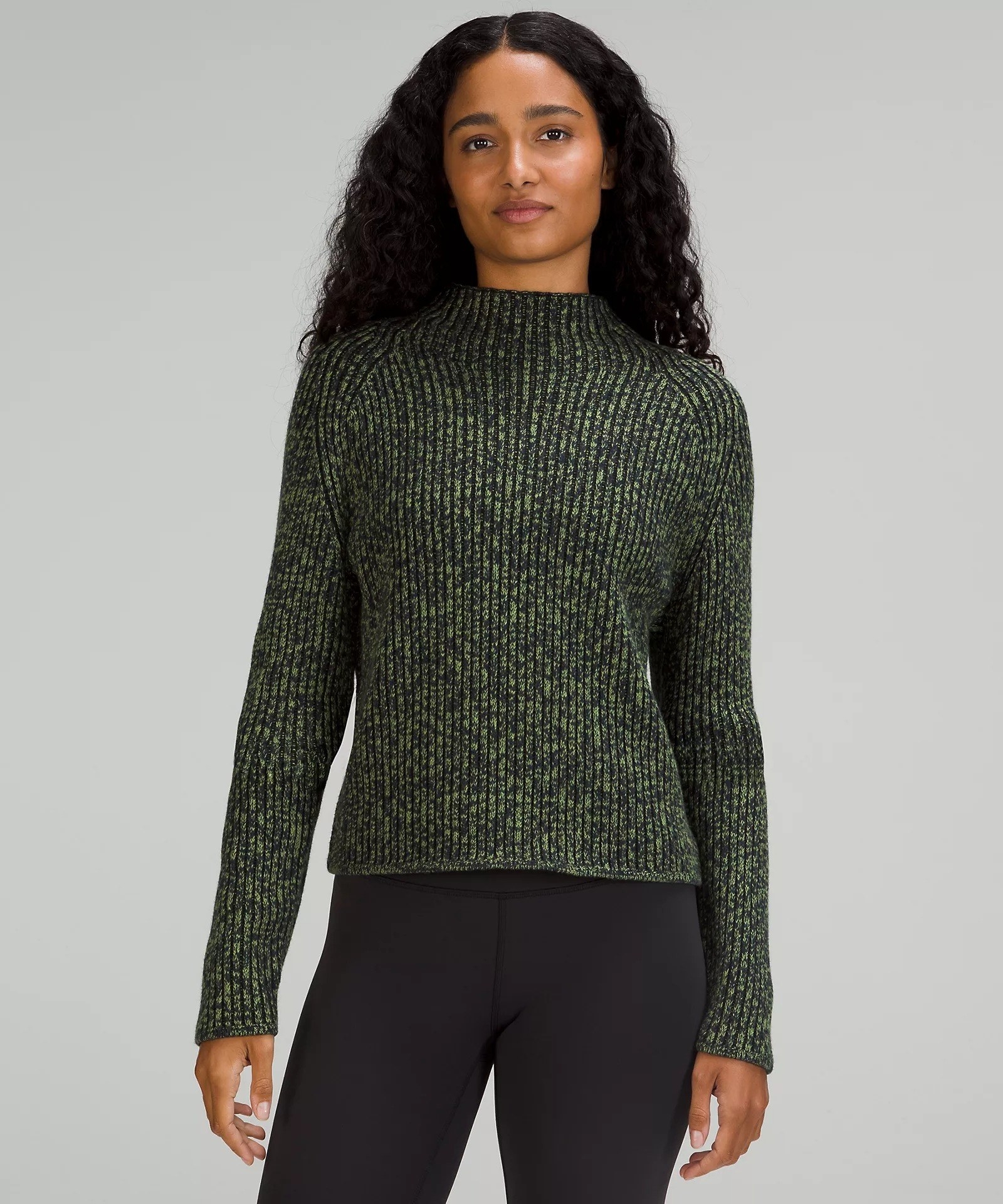 model wearing the sweater in green
