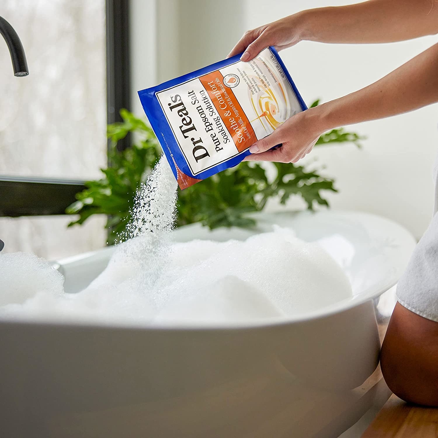a model pouring bath salts into a tub