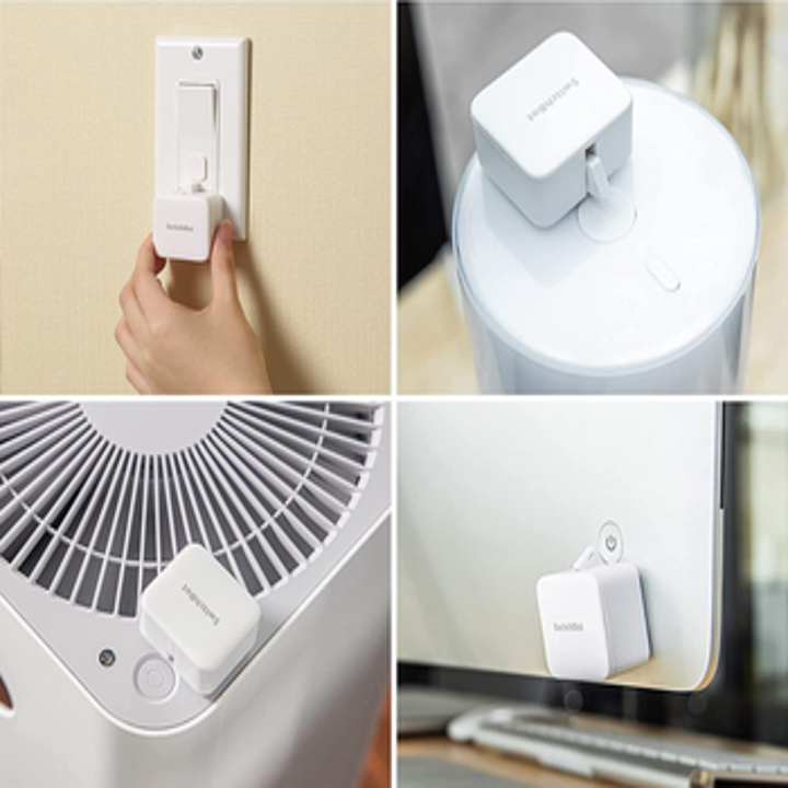 the white square shaped SwitchBot on a lightswitch, fan, and computer