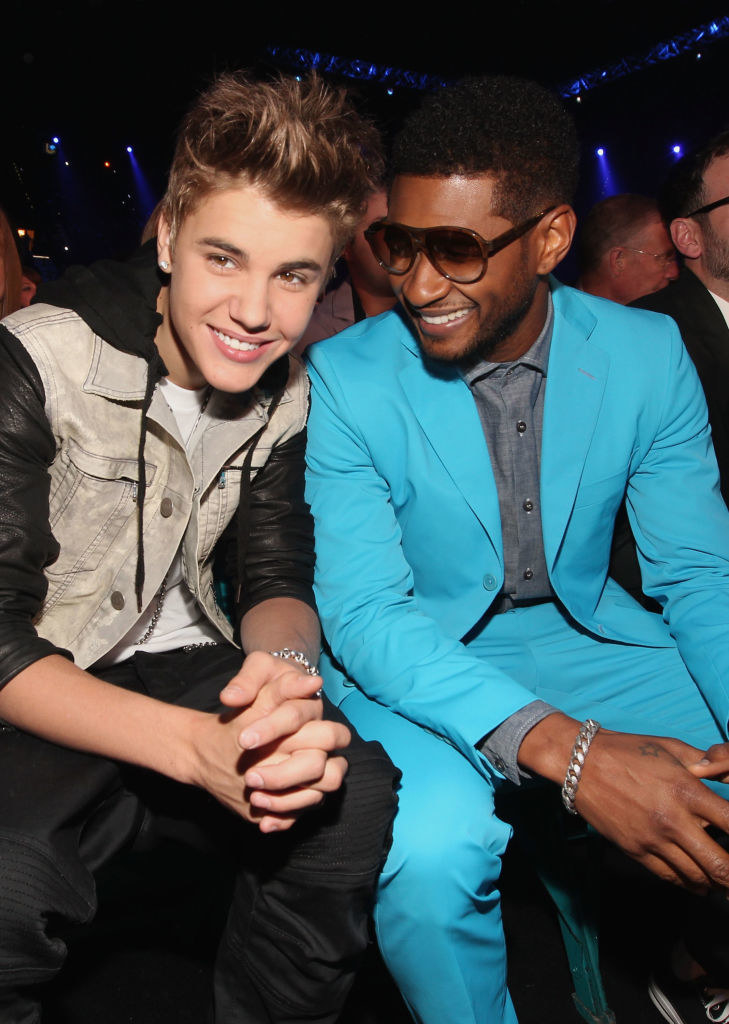 Justin and Usher sitting together and smiling