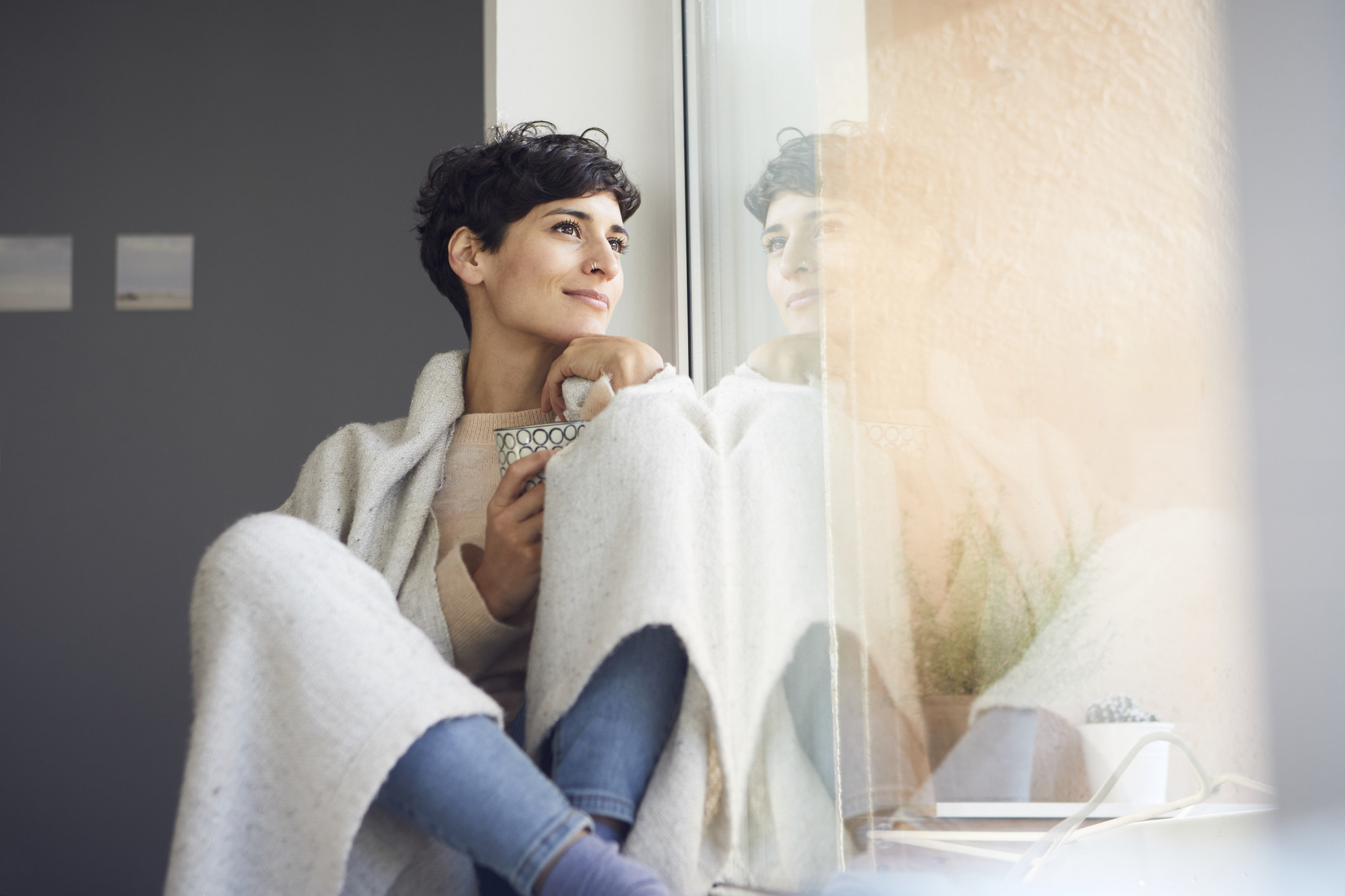 A woman looking outside her window