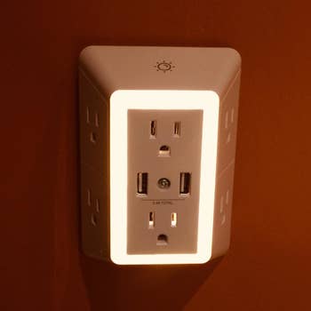 Reviewer photo of the outlet plugged in with light on