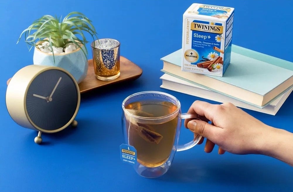 A box of tea with blue background and a cup of tea