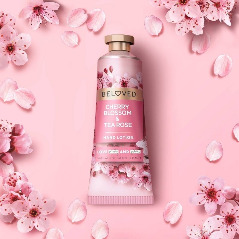 A photo of pink cherry blossom with a lotion in the middle
