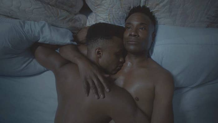 Two men laying in bed together